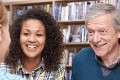 Group Of Mature Students Studying In Library